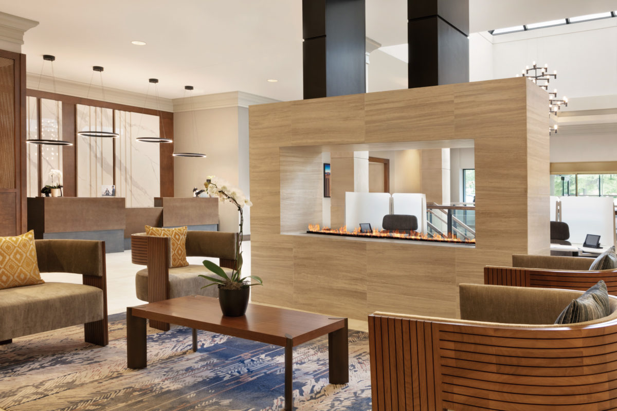 Lobby of CROWNE PLAZA PHILADELPHIA | KING OF PRUSSIA with front desk, seating area, and two way fire place