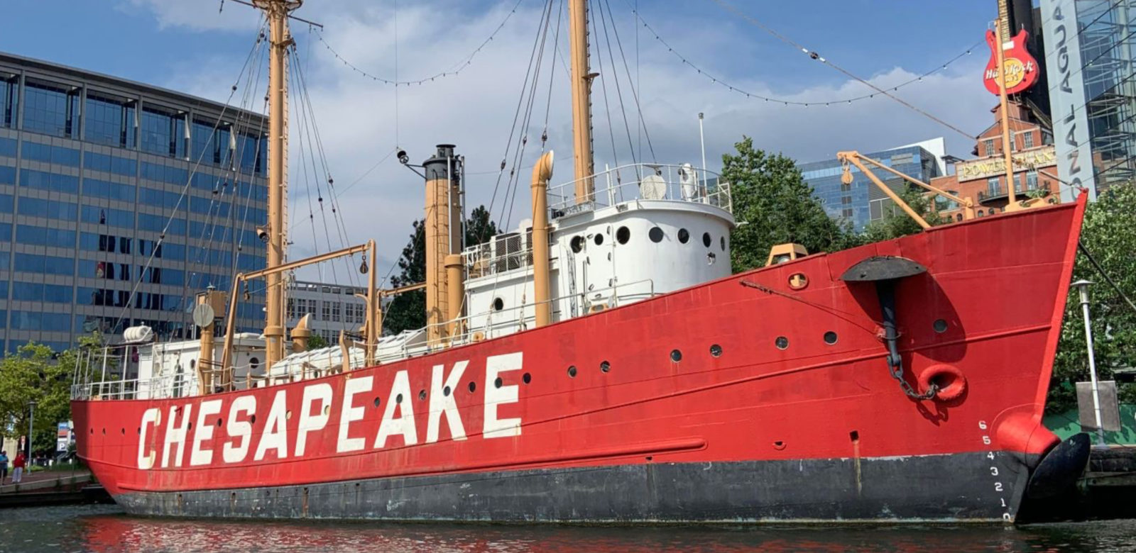 Large, red boat on harbor outside of Renaissance Baltimore Harborplace Hotel with word "Chesapeake" on the side in large white letters