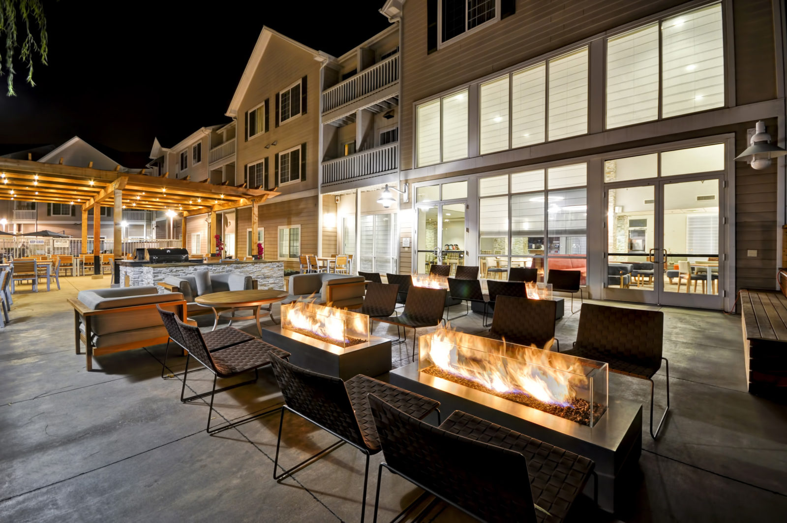 Patio with outdoor seating and sofas with firepit at HOMEWOOD SUITES OAKLAND WATERFRONT