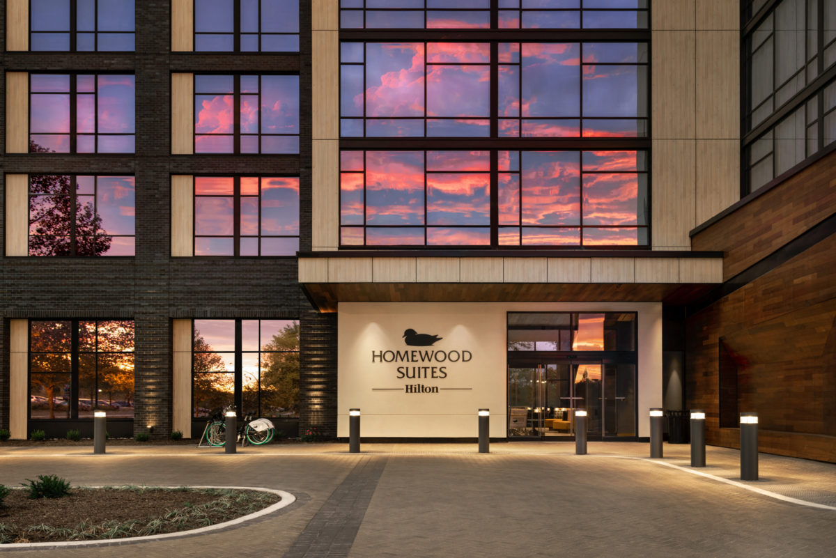 Exterior of HOMEWOOD SUITES WILMINGTON RIVERFRONT with sunset reflected on hotel