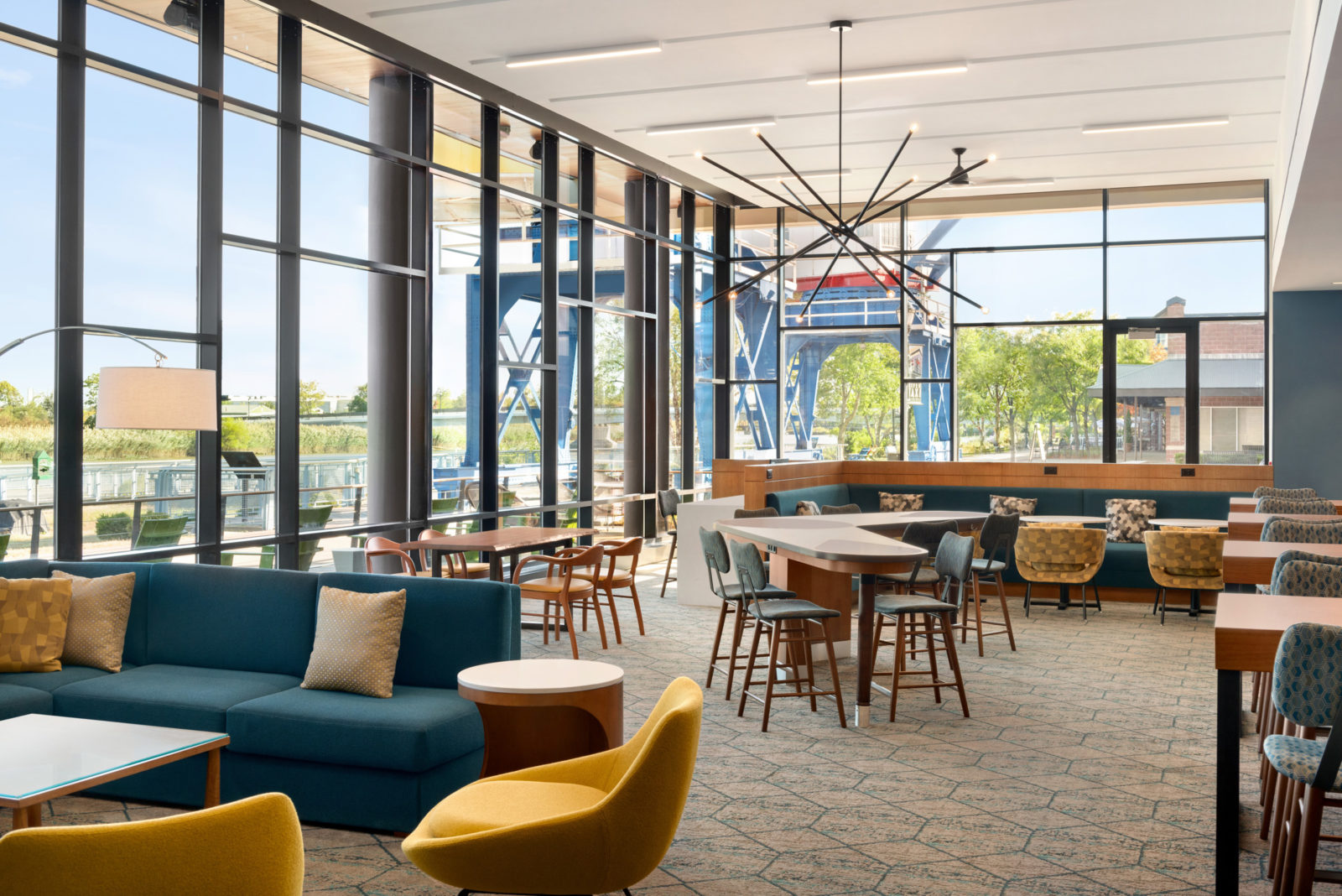 Seating area with blue and yellow chairs at HOMEWOOD SUITES WILMINGTON RIVERFRONT