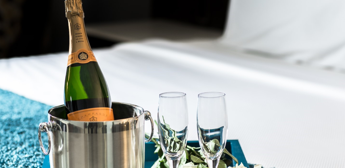 Room service champagne in ice bucket and 2 champagne flutes on bed at Westminster Hotel