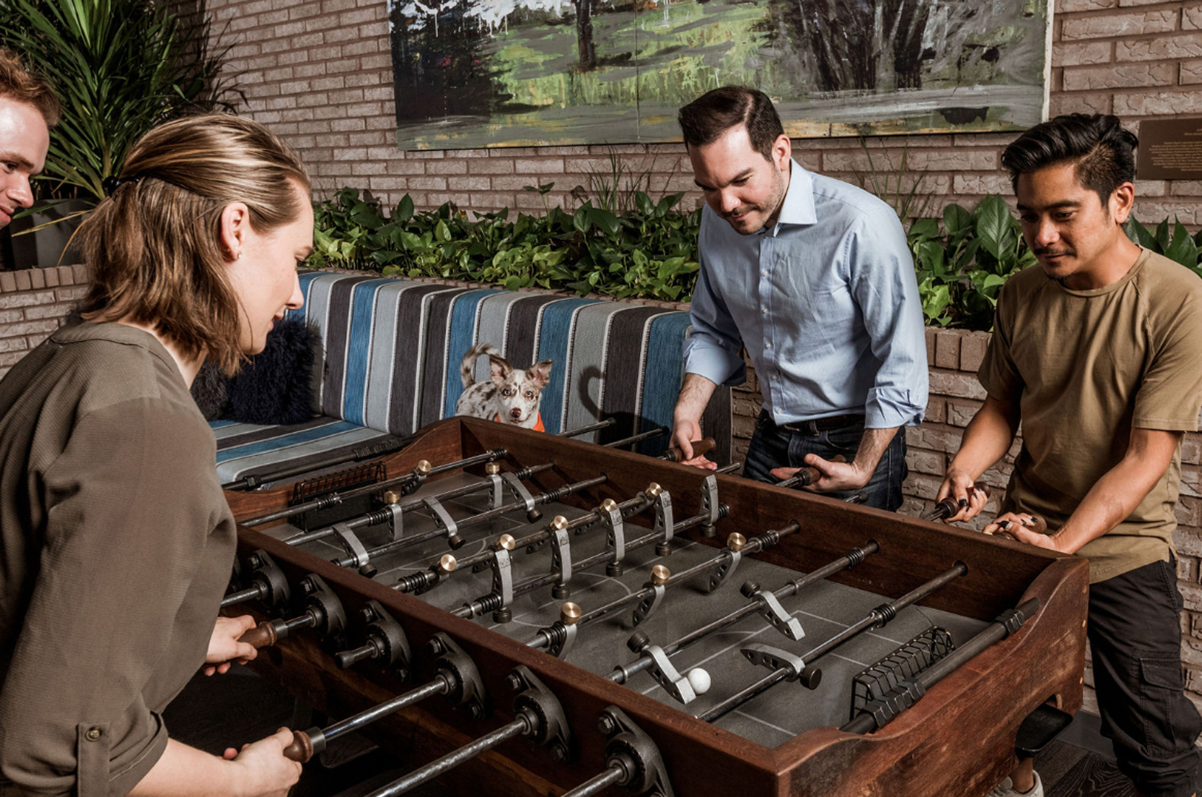 People playing foosball at Canopy Portland | Pearl District