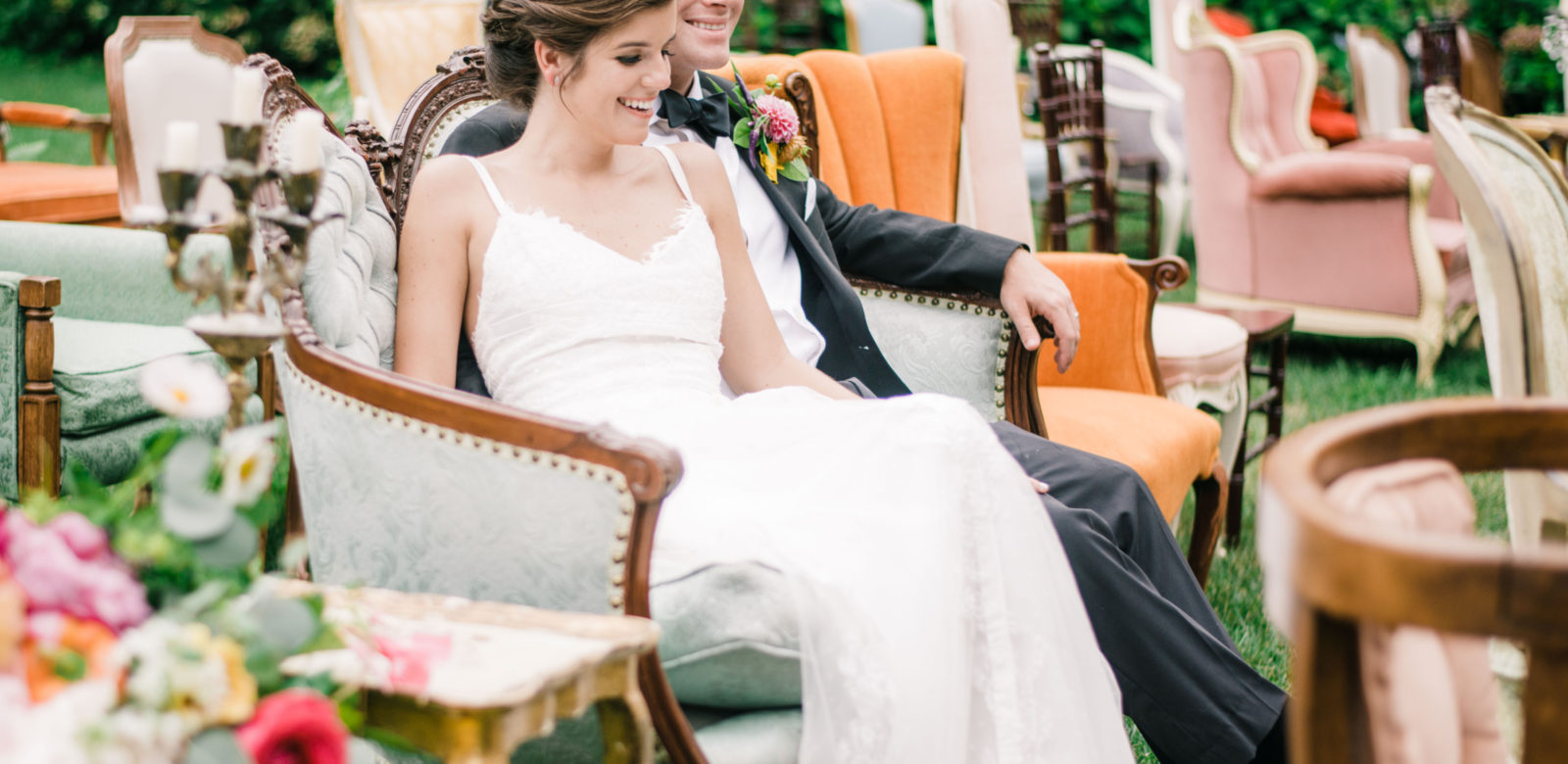 Wedding couple on love seat at Airlie
