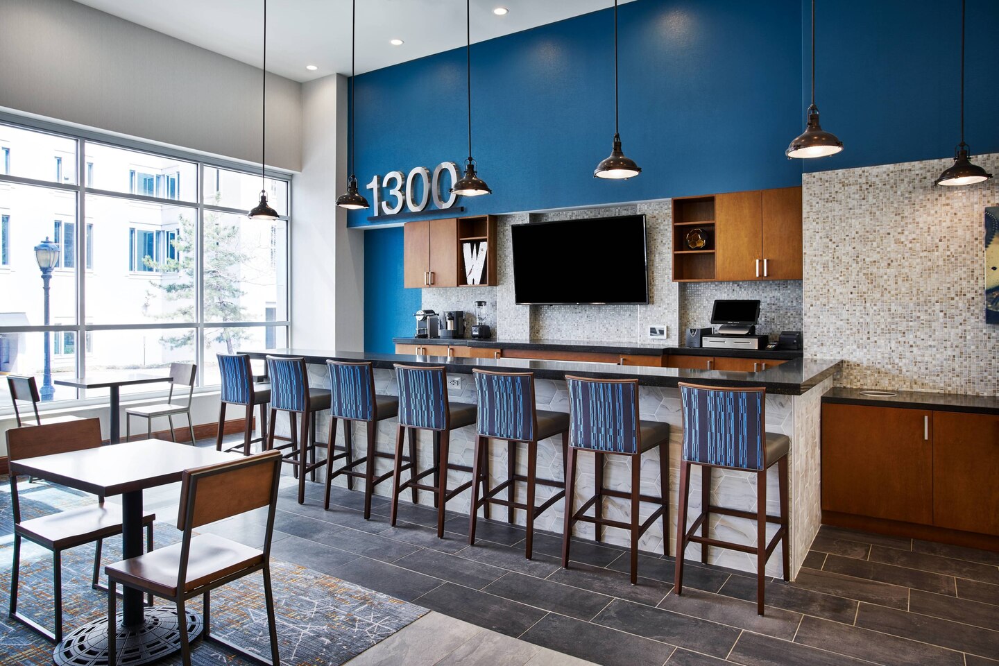 Bar with blue accents at 1300 Restaurant and Bar at Residence Inn Wilmington Downtown